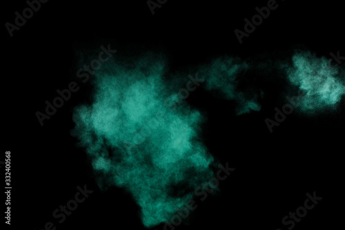 Aquamarine powder explosion on black background. Colored powder cloud. Colorful dust explode. Paint Holi.