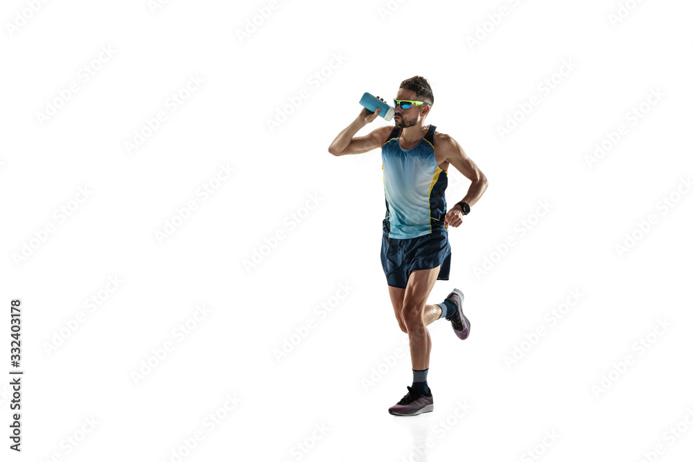 Triathlon male athlete running isolated on white studio background. Caucasian fit jogger, triathlete training wearing sports equipment. Concept of healthy lifestyle, sport, action, motion. Drinks Triathlon male athlete running isolated on white studio background. Caucasian fit jogger, triathlete training wearing sports equipment. Concept of healthy lifestyle, sport, action, motion. Drinks
