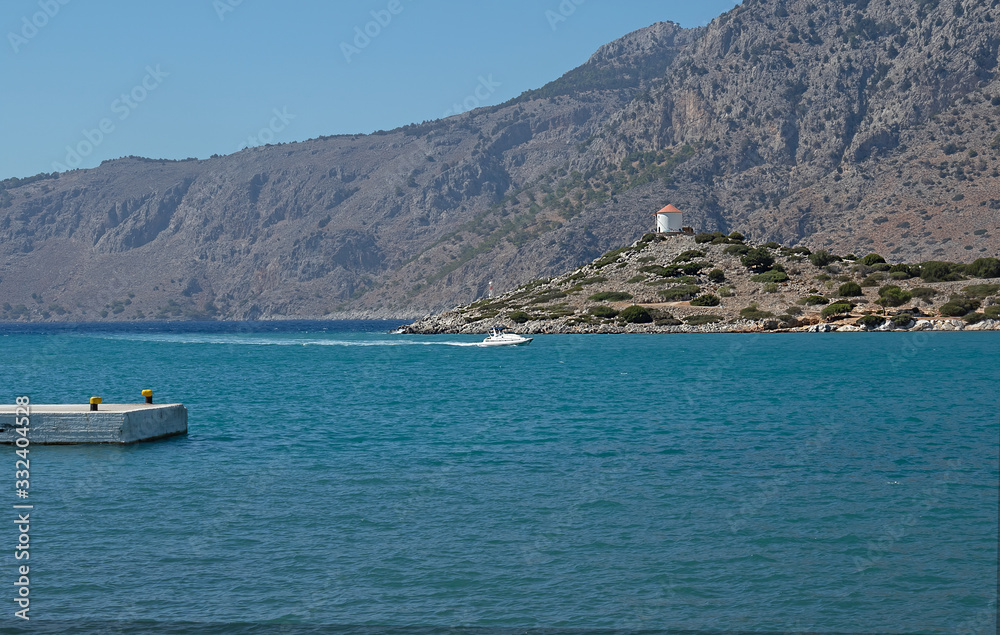 View from the promenade to the hills and the lighthouse. Natural background. Symi island, Mirarador, Greece