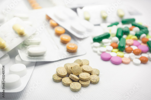 The concept of pills for treatment. Multi-colored pills in blisters on a white isolate. A serving of pills for today. Daily dose.