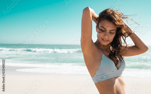 Beautiful tanned woman in bikini photo
