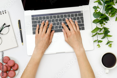 Top view of beautiful woman 's hands using laptop