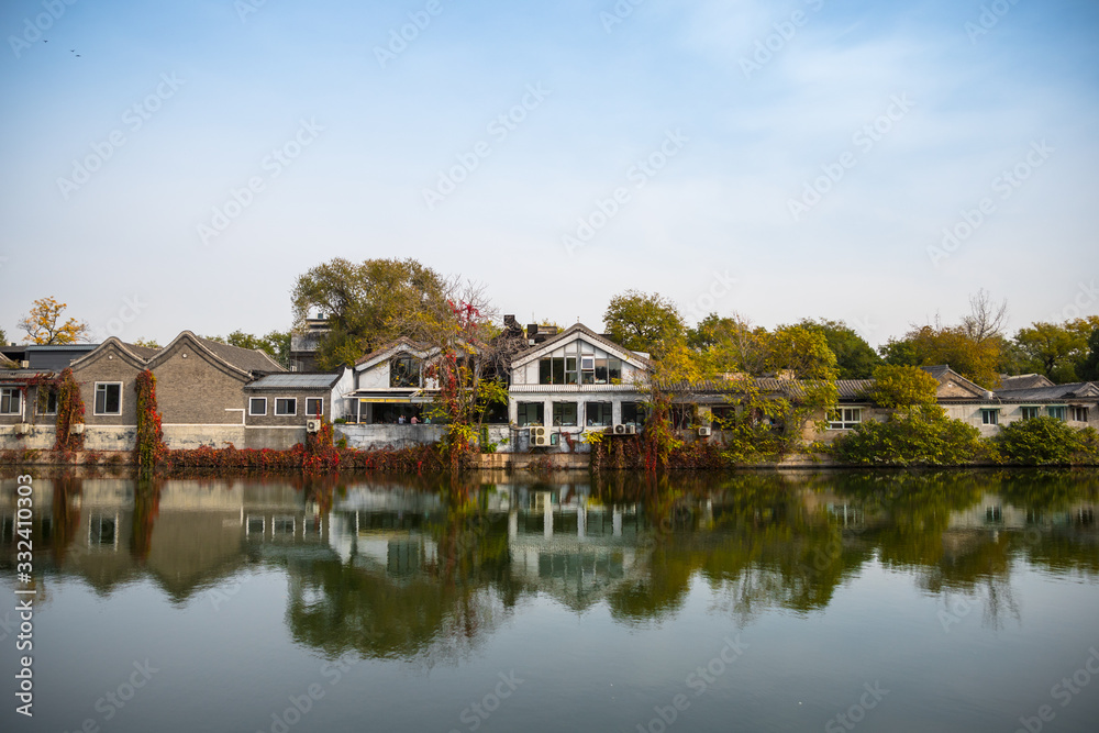 Reflection of Colourful Houses on Water during Autumn With Red Colours