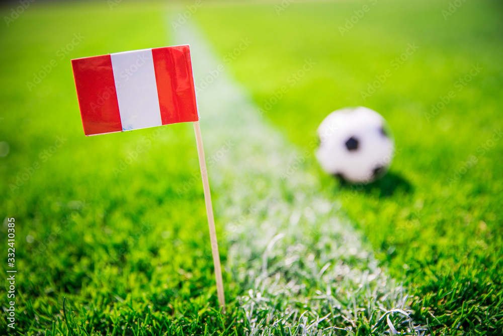 Obraz premium Peru national Flag and football ball on green grass. Fans, support photo, edit space