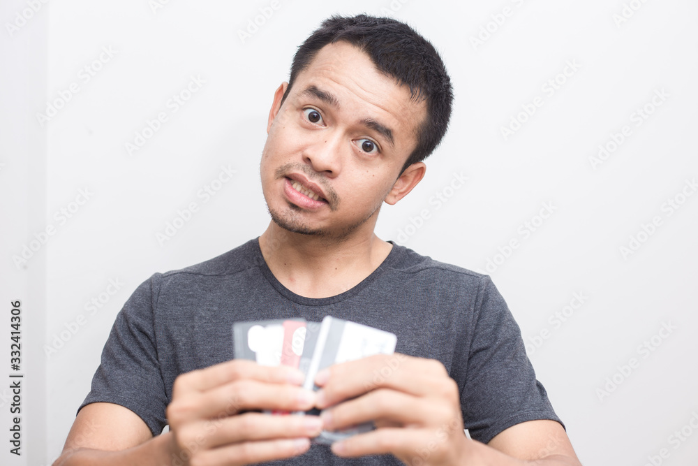 Business handsome man in grey shirt holding with many credit card
