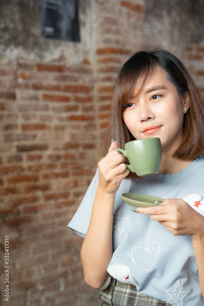 Pretty female drinking coffee in cozy cafe during lunch Pretty female drinking coffee in cozy cafe during lunch