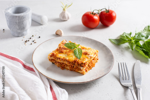 Delicious Homemade Italian Lasagna with bolognese and bachamel Sauce on white Background. Hot Tasty Lasagna with Parmesan Cheese. Restaurant menu, recipe
