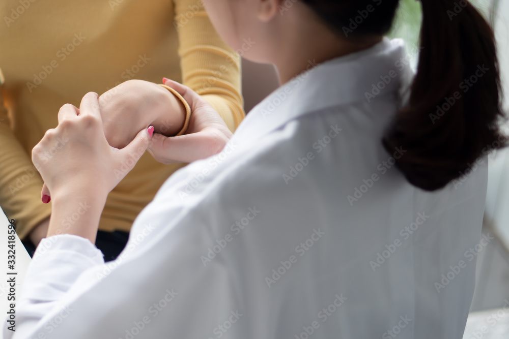 Obraz premium female orthopedic, bone doctor looking into the hand bone or wrist joint of woman patient; concept of dedicated orthopedic surgery, bone doctor test, therapist, medical worker on the job