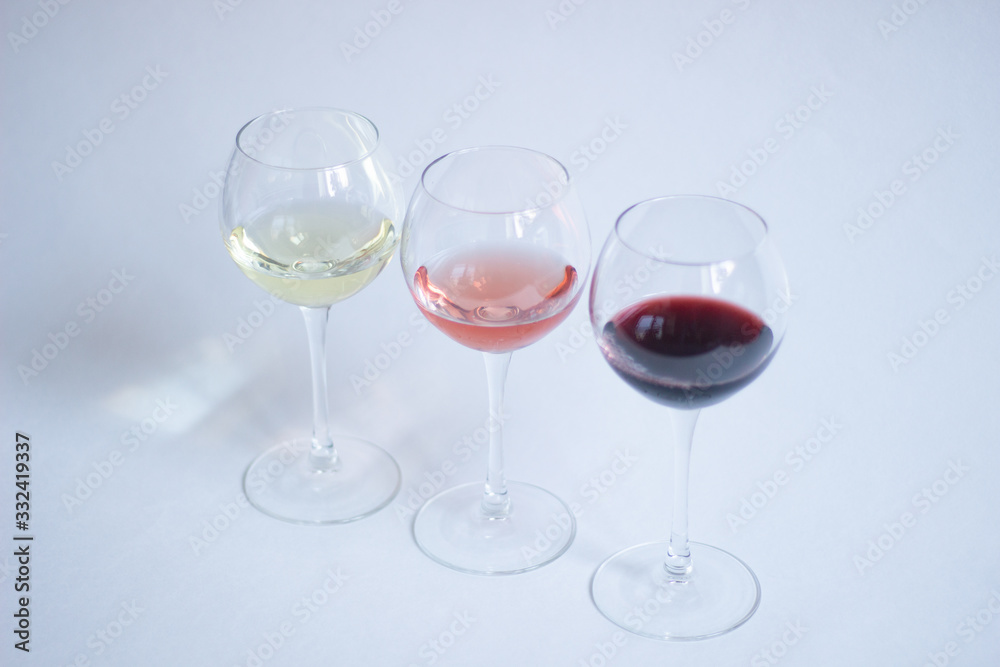 White, pink, red wine in glasses on white background isolated