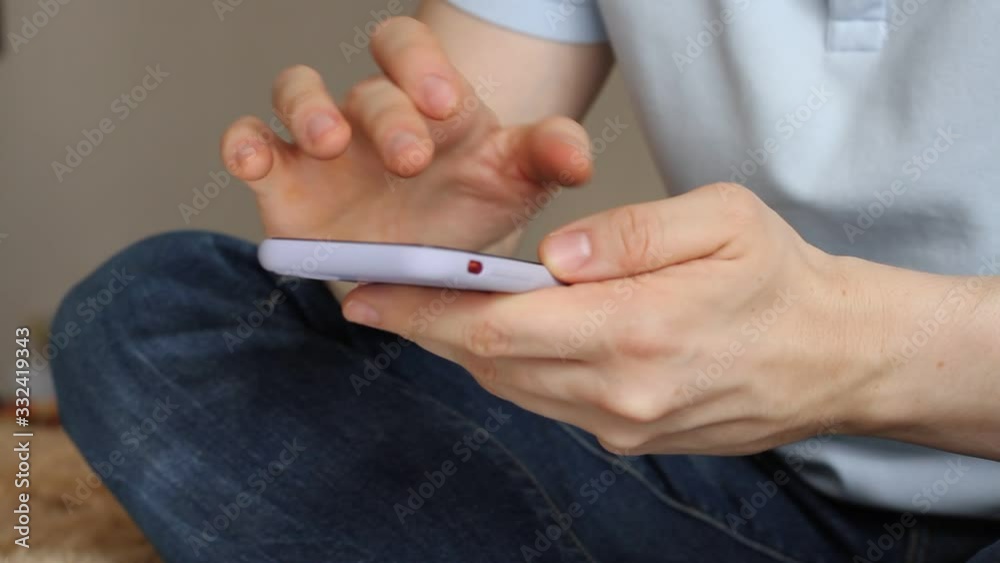 Man using smartphone scrolling through social media, doing swiping, scrolling gestures. Male texting SMS with mobile telephone. Man using smartphone scrolling through social media, doing swiping, scrolling gestures. Male texting SMS with mobile telephone.