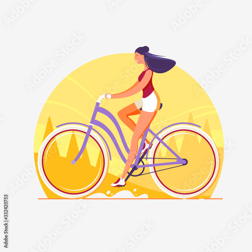 A woman rides a bicycle. Cityscape.