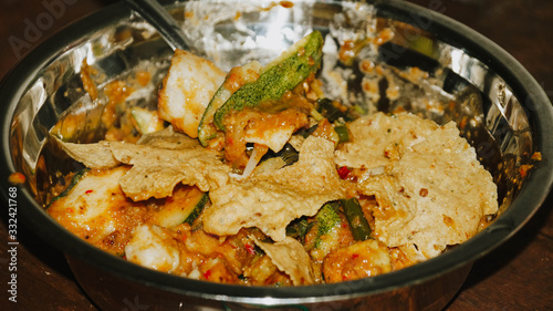 Close-up of Pecel - Traditional Javanese salad, consisting of mixed vegetables in a peanut sauce dressing, served with omelet.