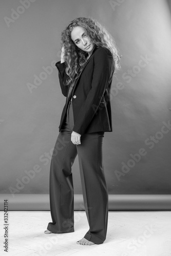 beautiful girl curly magnificent hair, in the studio, background