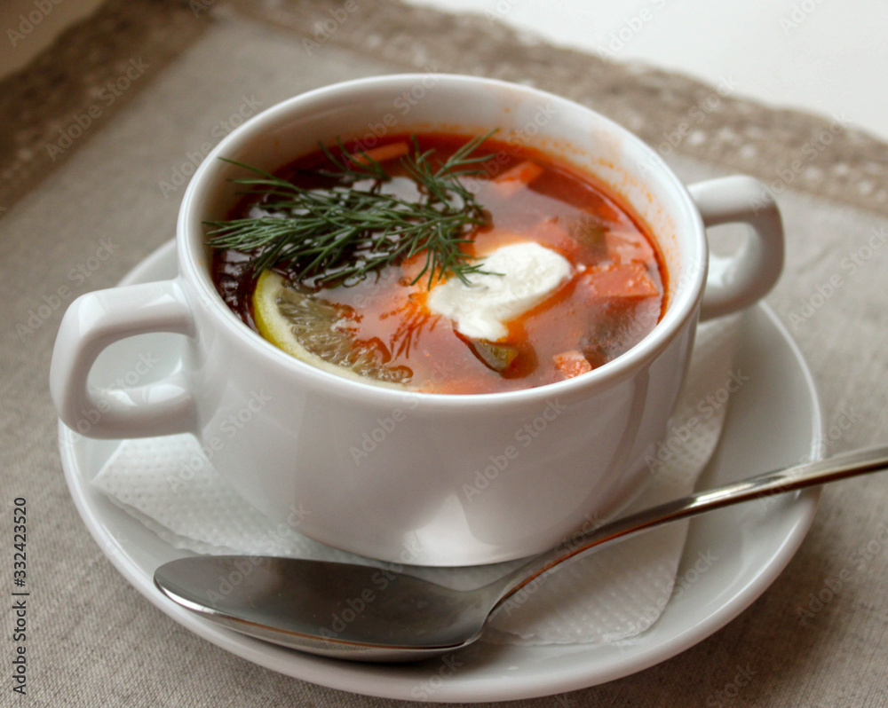 Hot meat Russian traditional tomato soup saltwort Solyanka on white bowl on natural linen background Hot meat Russian traditional tomato soup saltwort Solyanka on white bowl on natural linen background