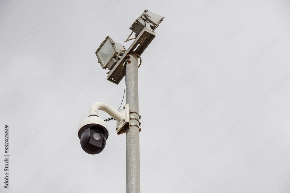 CCTV security camera on pole watching the area CCTV security camera on pole watching the area