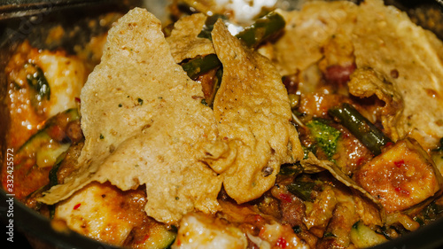 Close-up of Pecel - Traditional Javanese salad, consisting of mixed vegetables in a peanut sauce dressing, served with omelet.