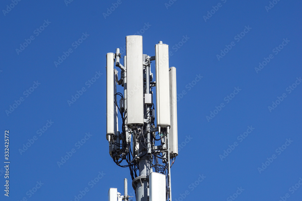 Close up white color antenna repeater tower on blue sky Close up white color antenna repeater tower on blue sky
