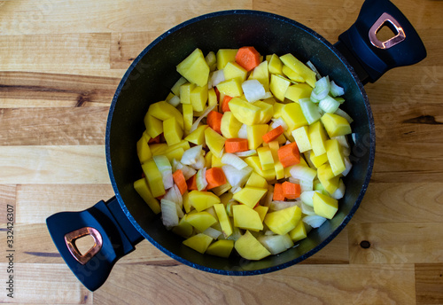 Various fresh vegetables in a black pot - colorful fresh soup