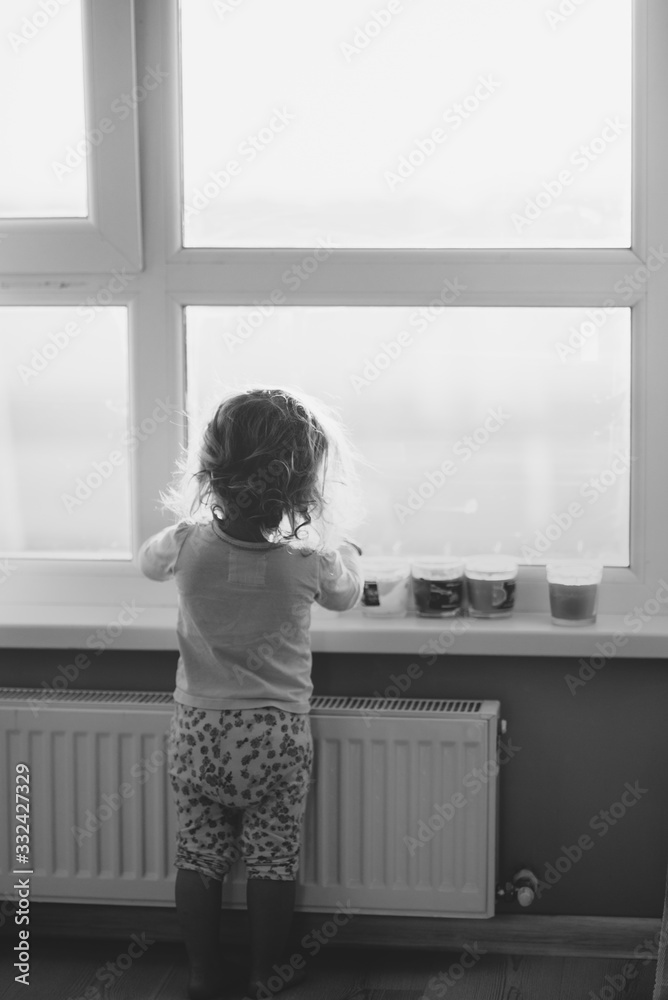 Kid looks in the window back view monochrome Kid looks in the window back view monochrome