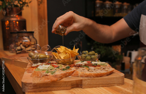 sandwiches on a wooden tray with chips