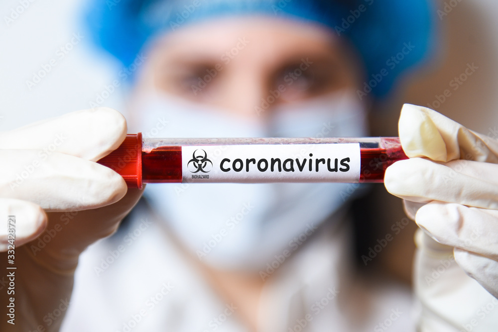 test tube in hands with coronovirus (covid-19) blood test test tube in hands with coronovirus (covid-19) blood test