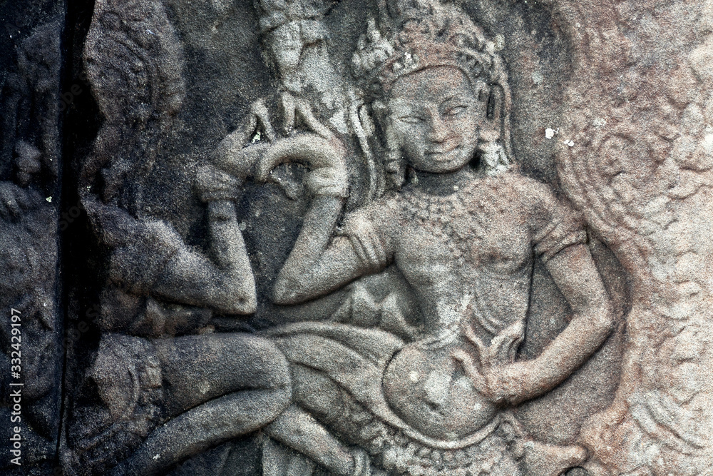 Dancing woman on 12th century ruined relief of the Bayon temple, Cambodia. Historical artwork on column of Khmer landmark in Angkor. UNESCO world heritage site Dancing woman on 12th century ruined relief of the Bayon temple, Cambodia. Historical artwork on column of Khmer landmark in Angkor. UNESCO world heritage site