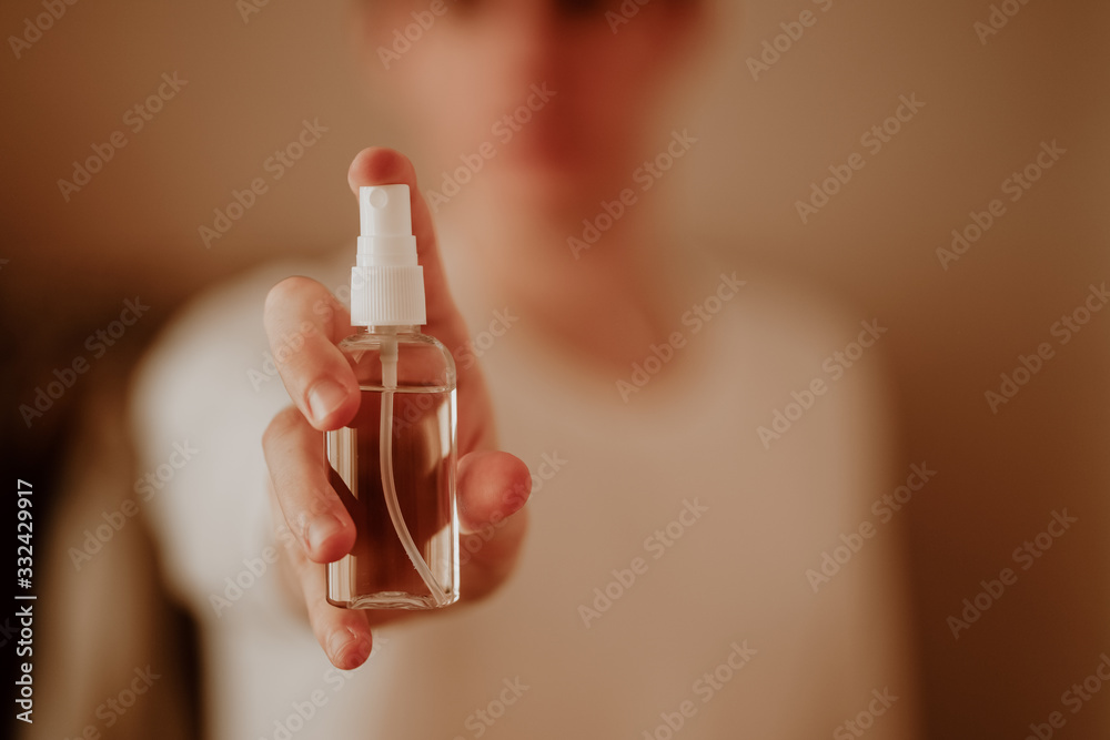 Man in protective mask and with antibacterial antiseptic gel for hands disinfection and health protection prevention during flu virus outbreak, epidemic and infectious diseases Man in protective mask and with antibacterial antiseptic gel for hands disinfection and health protection prevention during flu virus outbreak, epidemic and infectious diseases