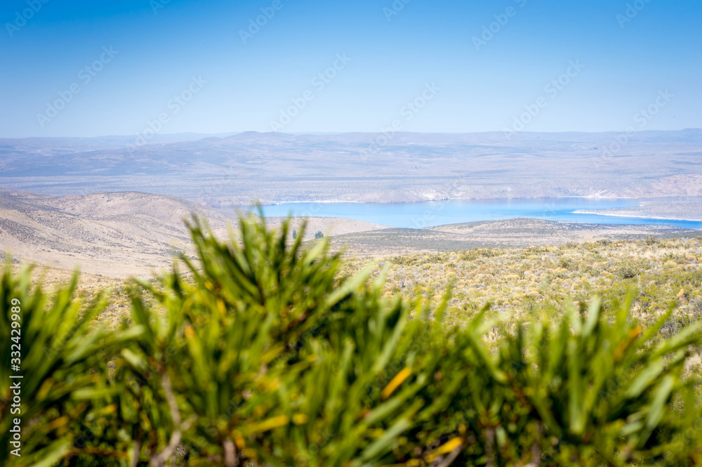 Turquoise lake and mountains in the background. Neuquén, Argentina. Turquoise lake and mountains in the background. Neuquén, Argentina.