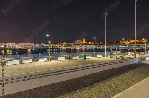 Night view of the Port of Malaga with the famous cathedral in the background. Spain.
