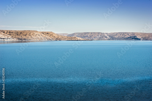 Turquoise lake and mountains in the background. I walk along the Neuquén highway, Argentina.