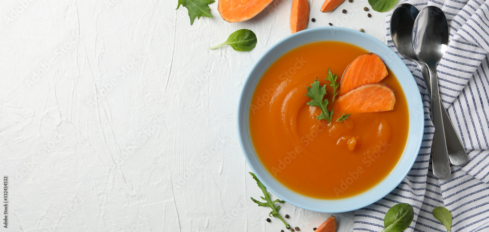 Sweet potato cream soup on white background, top view Sweet potato cream soup on white background, top view