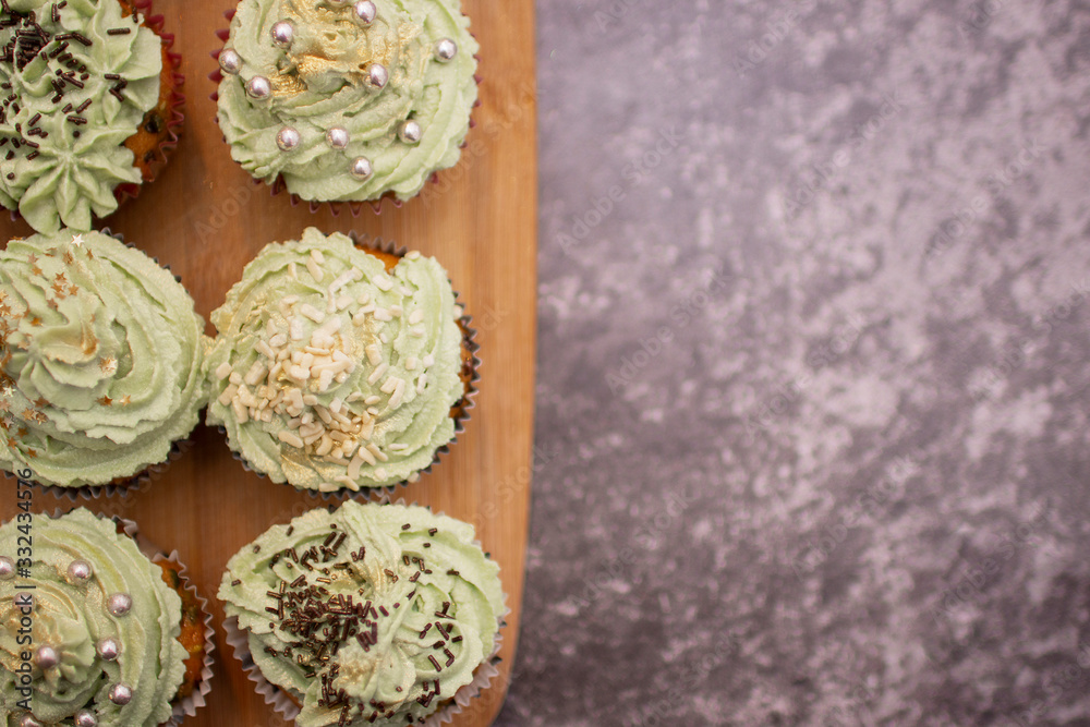 Cupcakes with green cream and gold powder. View from above