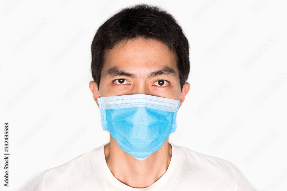 Asian man wearing face mask for protect corona virus and air pollution, pm 2.5, on white background. Medical and healthcare concept Asian man wearing face mask for protect corona virus and air pollution, pm 2.5, on white background. Medical and healthcare concept