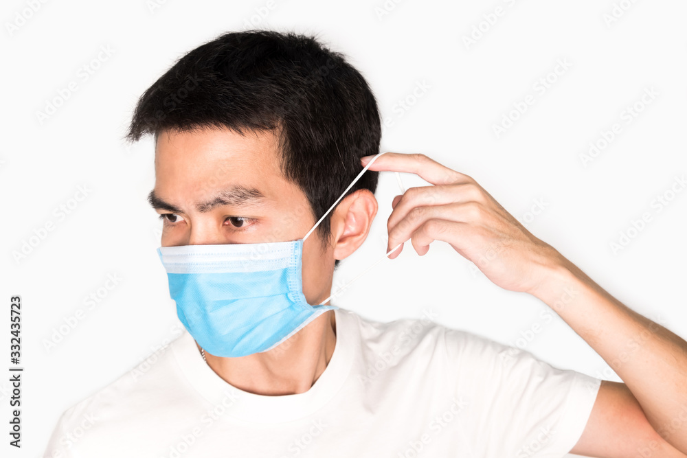 Asian man wearing face mask for protect corona virus and air pollution, pm 2.5, on white background. Medical and healthcare concept Asian man wearing face mask for protect corona virus and air pollution, pm 2.5, on white background. Medical and healthcare concept