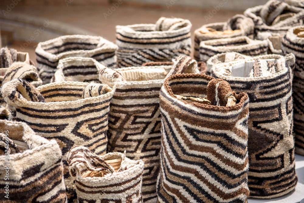 Close up photo with shallow depth of field of local Colombian bags with white, brown and black pattern called mochilas.