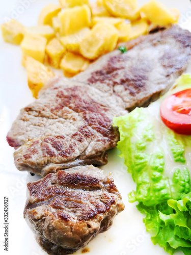 juicy steak beef meat with tomato and potatoes