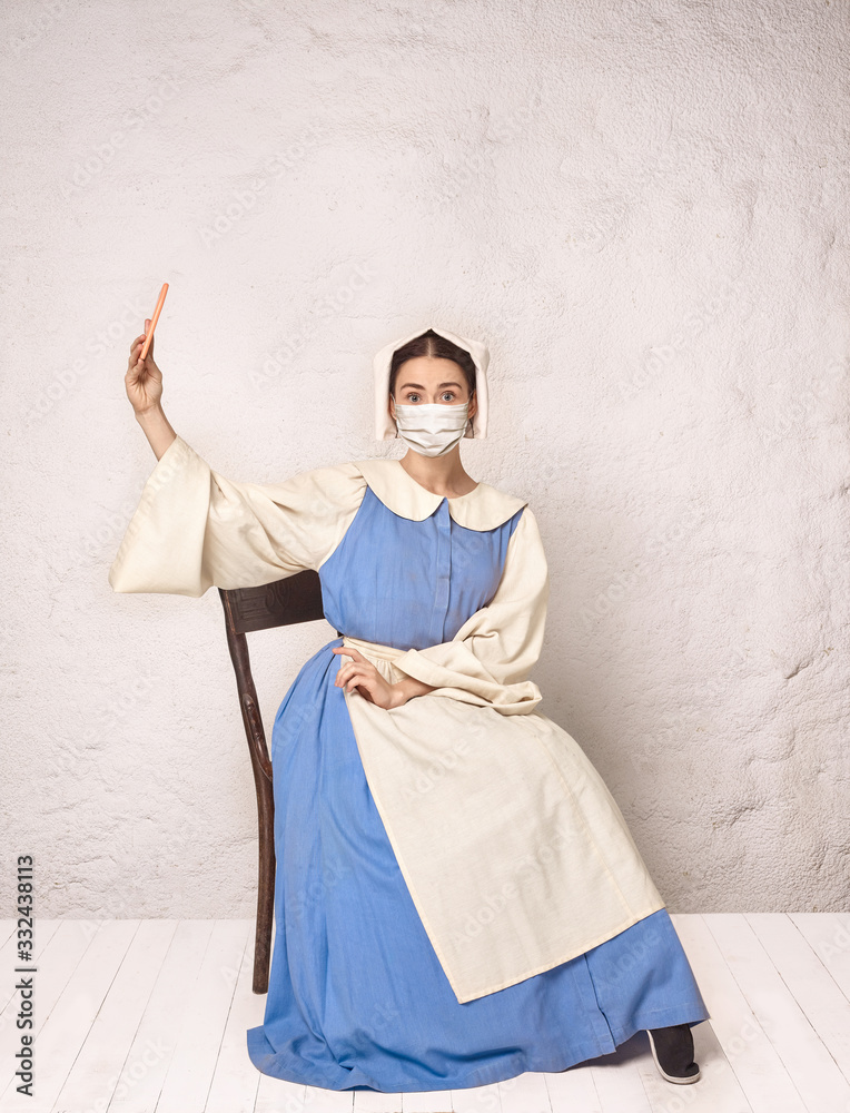 Medieval young woman as a medieval lady milkmade wearing protective face mask against corovanirus spread. Concept of comparison of eras, healthcare and medicine, prevention flu virus, protection. Medieval young woman as a medieval lady milkmade wearing protective face mask against corovanirus spread. Concept of comparison of eras, healthcare and medicine, prevention flu virus, protection.