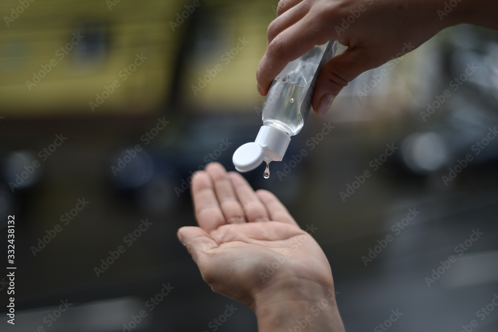 Woman washing her hands with antibacterial soap gel