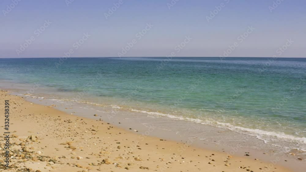 Sea water washes clean empty sandy wild beach, calm sea or ocean, tide or low tide at morning or evening. Aerial view, drone shoot Sea water washes clean empty sandy wild beach, calm sea or ocean, tide or low tide at morning or evening. Aerial view, drone shoot