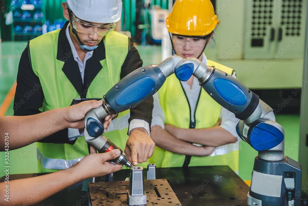 Asian male ,female engineer factory inspection with robot ai machine