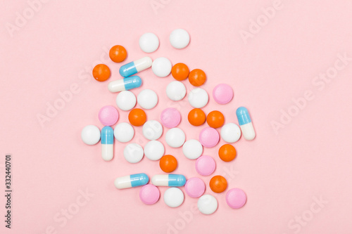 Assorted pharmaceutical medicine pills, tablets and capsules on pink background. Free space. Healthcare concept Close-up