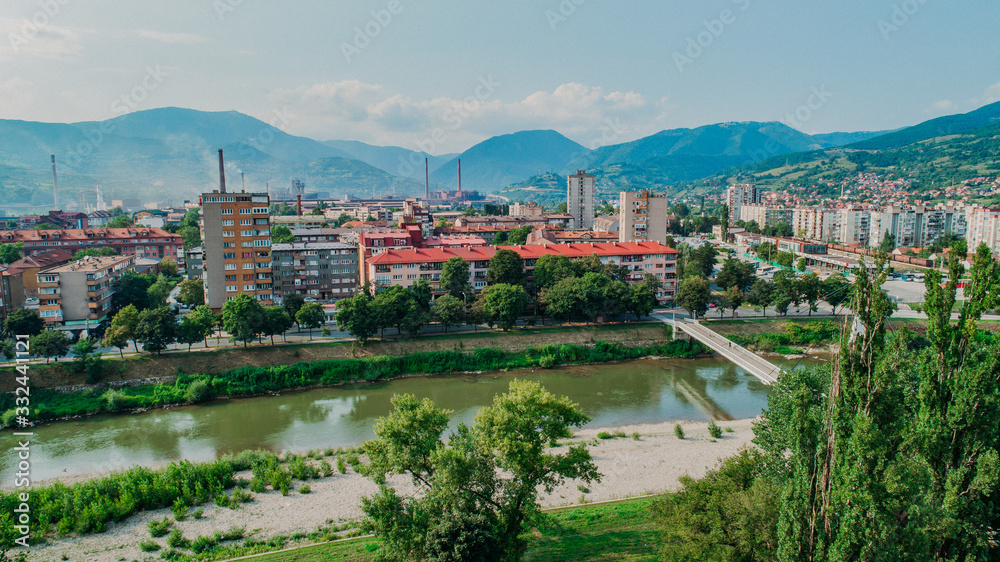 city photographed from air by drone. Old balkan buildings and communism type of architecture. Zenica - Bosnia and Herzegovina. Balkan city with nature around.