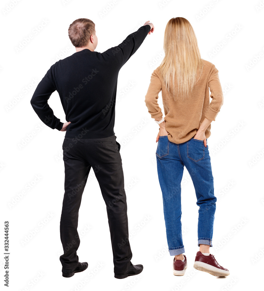 Back view of couple in sweater pointing. Back view of couple in sweater pointing.