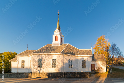 ULSTEINVIK, NORWAY - 2016 NOVEMBER 06. Ulsteinvik Church with autumn color and blue skye. photo