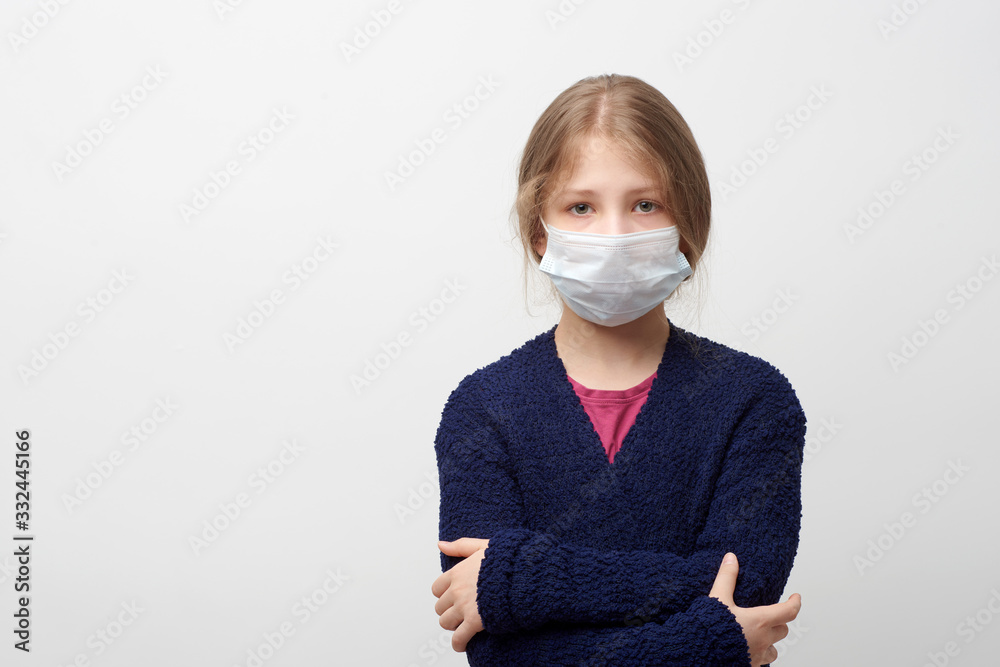 Young girl wearing face mask and hugging herself looking at camera Young girl wearing face mask and hugging herself looking at camera