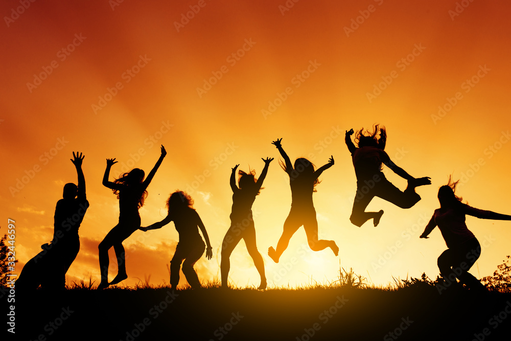 Group of people jumping against the sunset Group of people jumping against the sunset