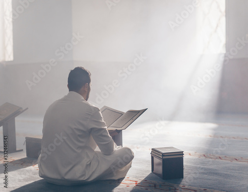 Quran - holy book of Islam mosque Muslim in mosque enuntiat Quran in Ramadan photo