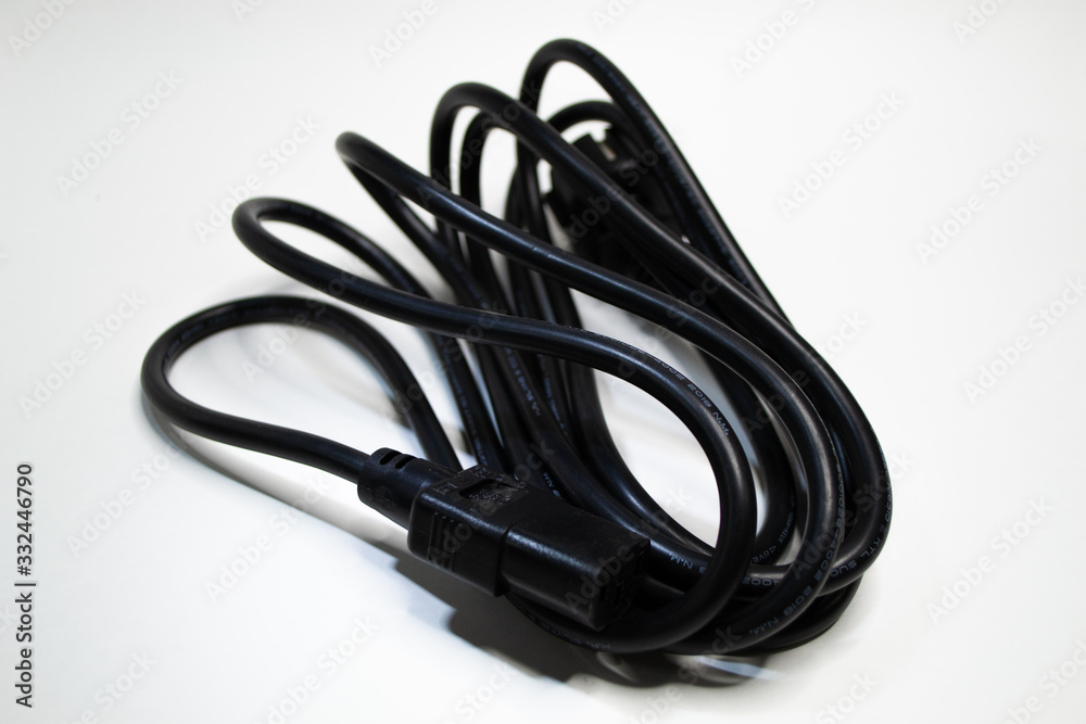 Black wire twisted into a small ball isolated on white background. Electronic plug european model with ground 220 voltage for PC. Black wire twisted into a small ball isolated on white background. Electronic plug european model with ground 220 voltage for PC.