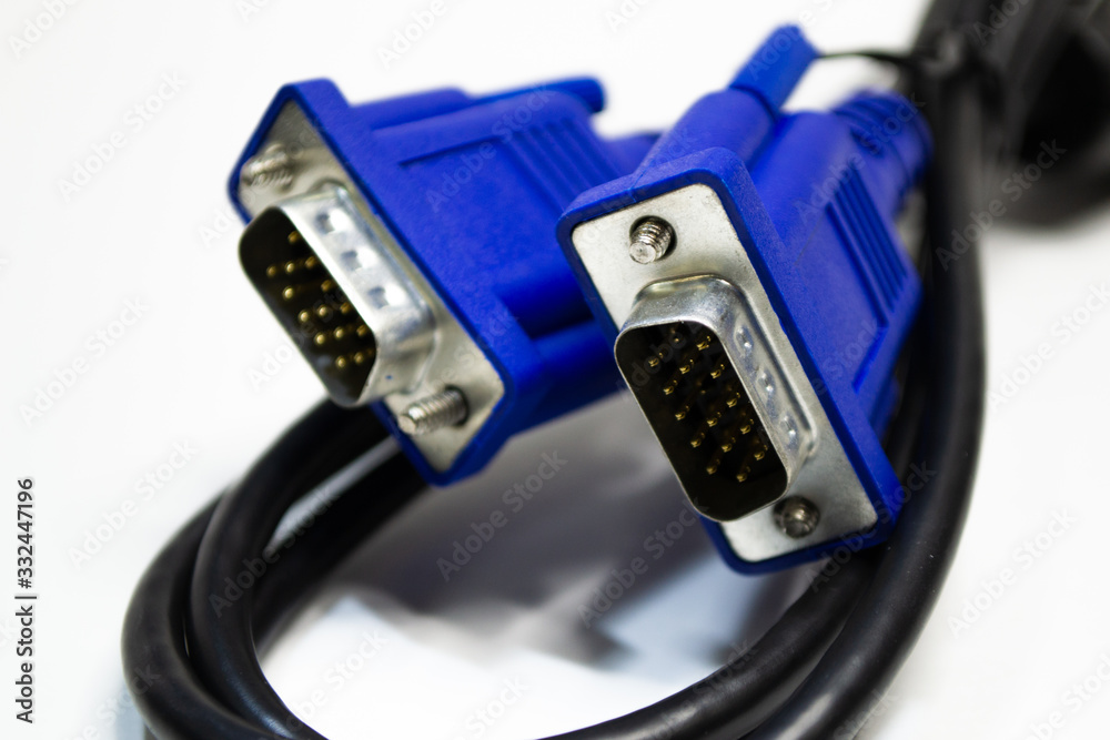 DVI and D-SUB cable for LCD and CRT monitors isolated on white background. Electronic black wire with blue connector. DVI and D-SUB cable for LCD and CRT monitors isolated on white background. Electronic black wire with blue connector.
