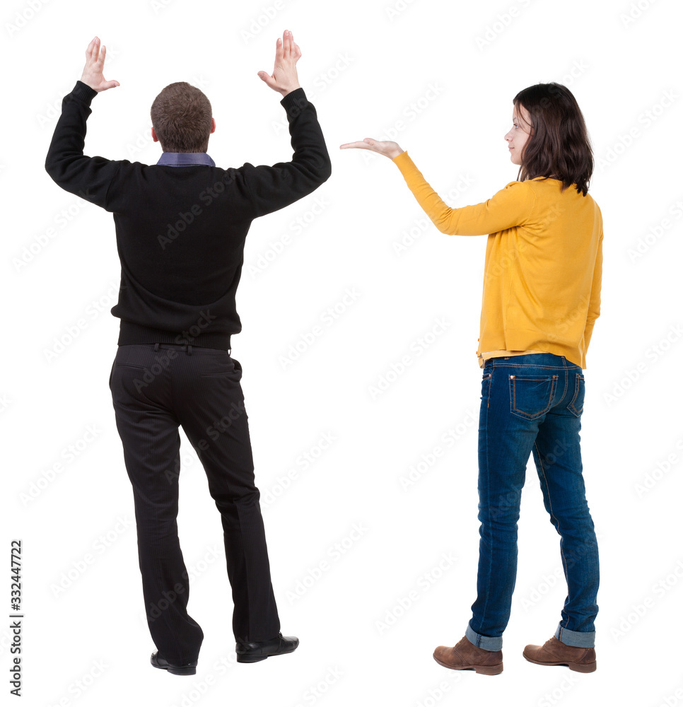 Back view of couple in sweater pointing. Back view of couple in sweater pointing.